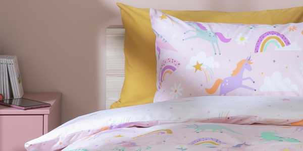 A kid's bedding with unicorn and rainbow print.